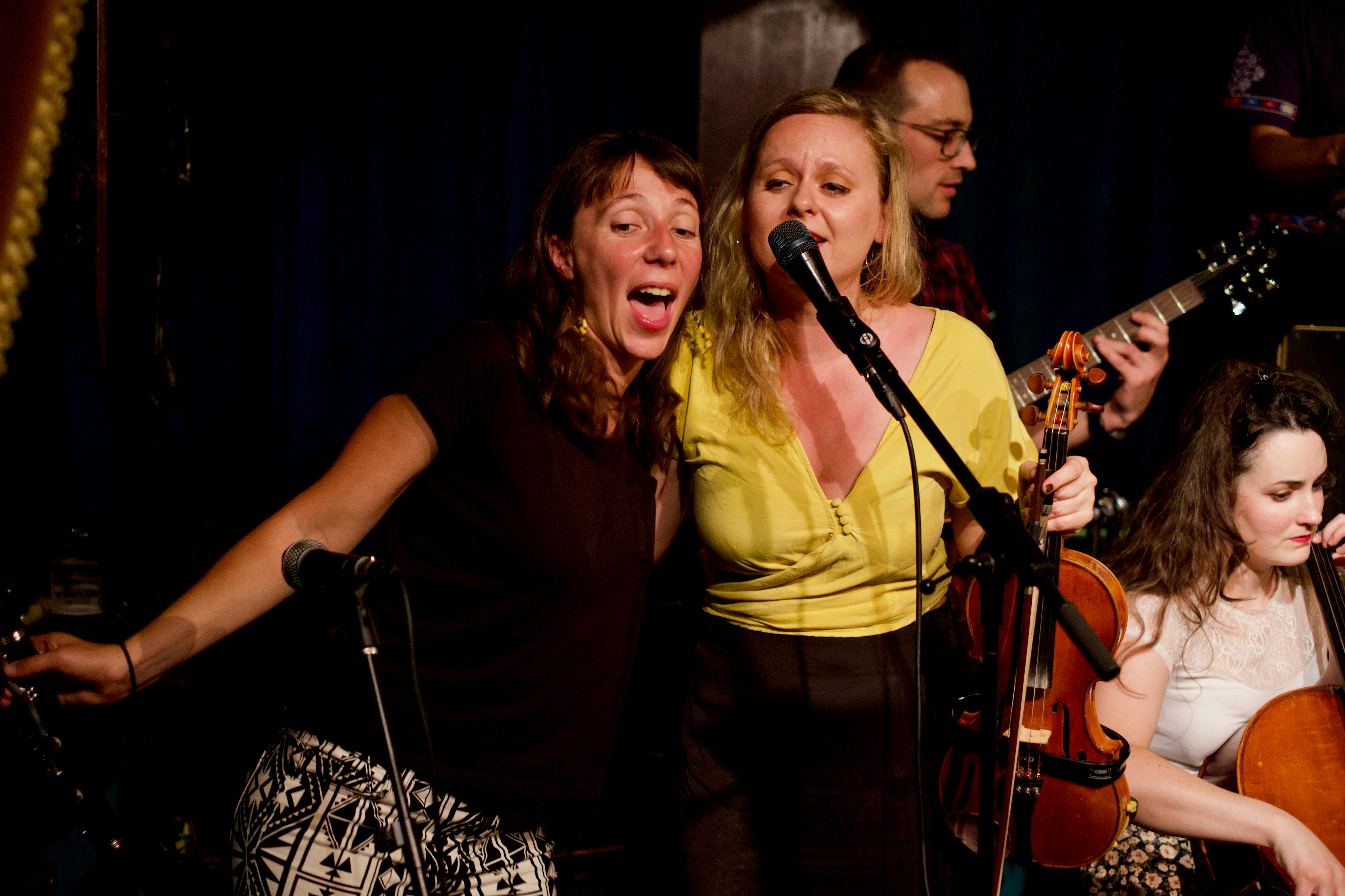 People singing together at a small venue